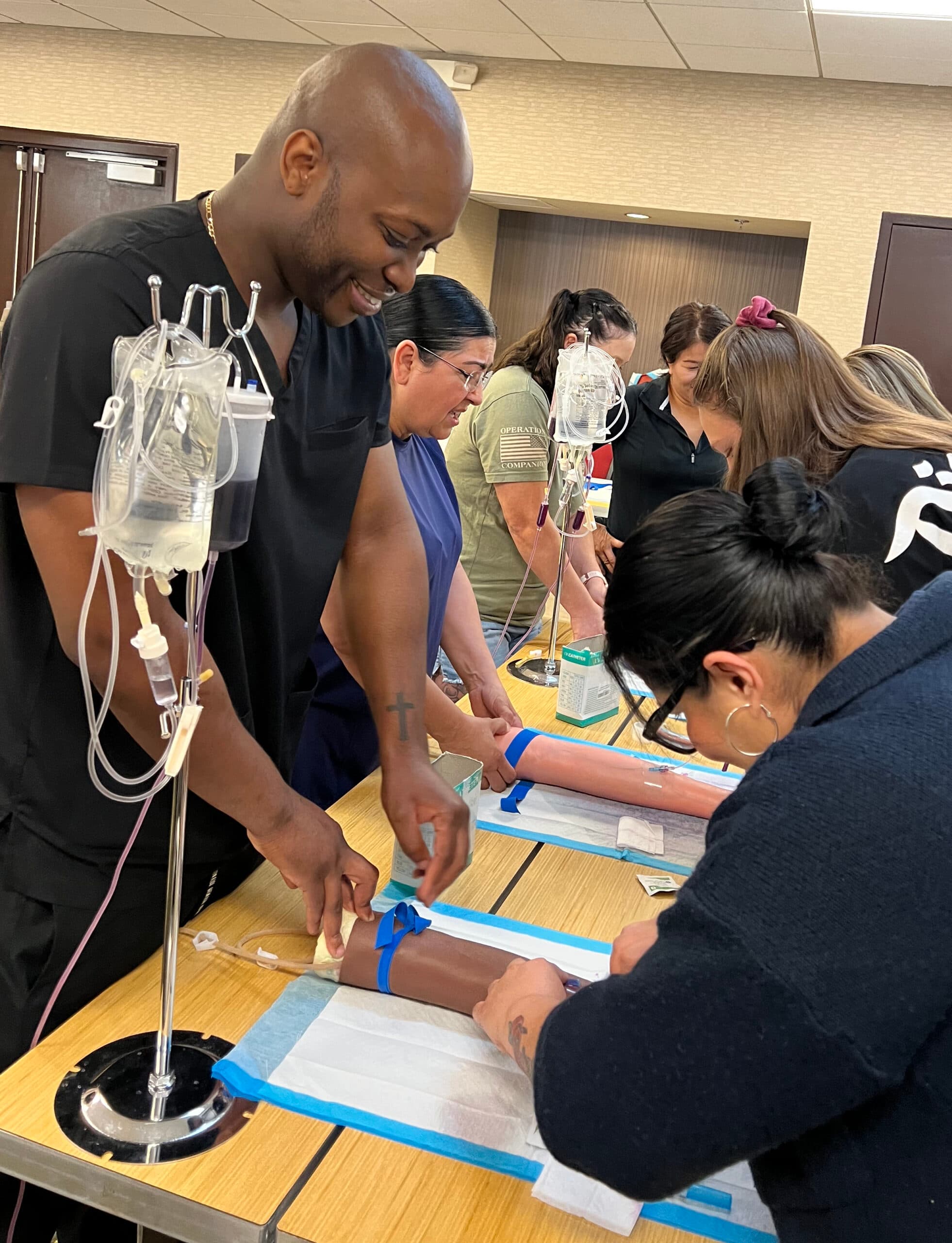 An instructor guiding students through hands-on clinical training
